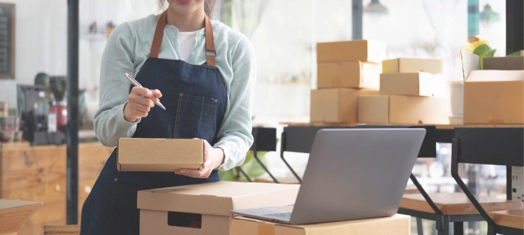 Person checking inventory stock while looking at a laptop