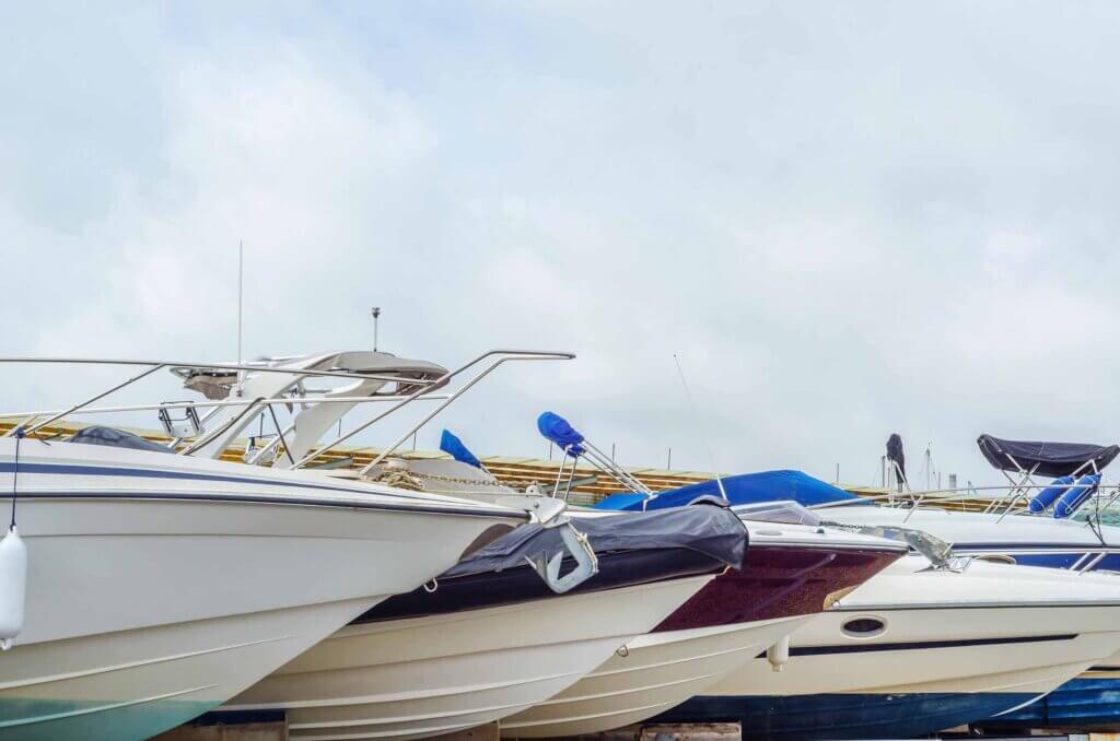 Boat on stand on the shore, close up on the part of the yacht, luxury ship, maintenance and parking place boat
